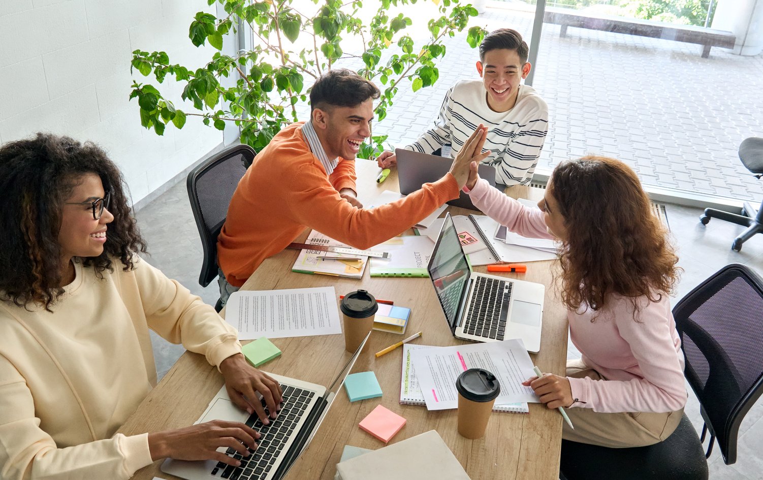 Team Working Together in Office Using Laptops